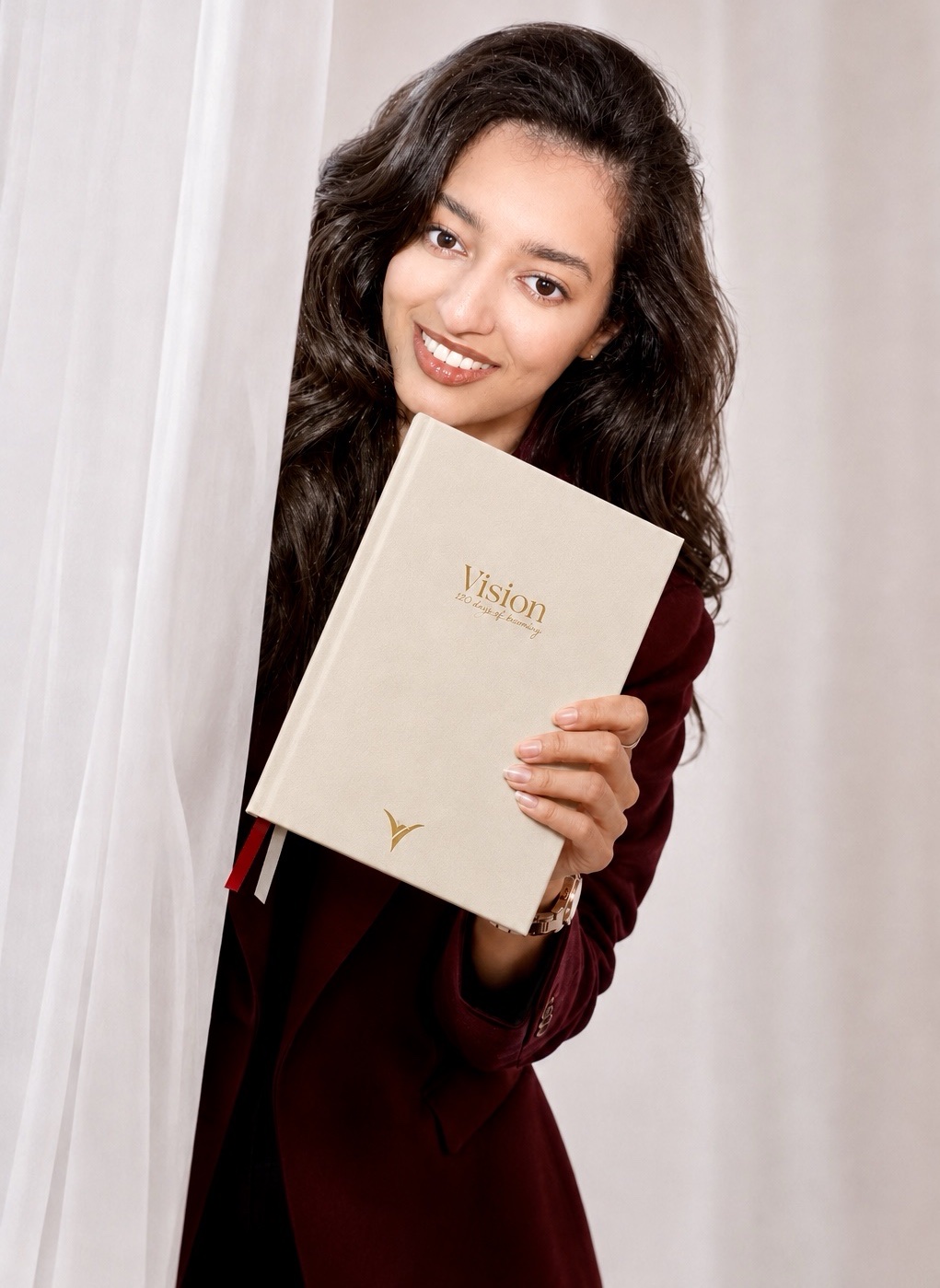 Smiling and holding up the Vision planner