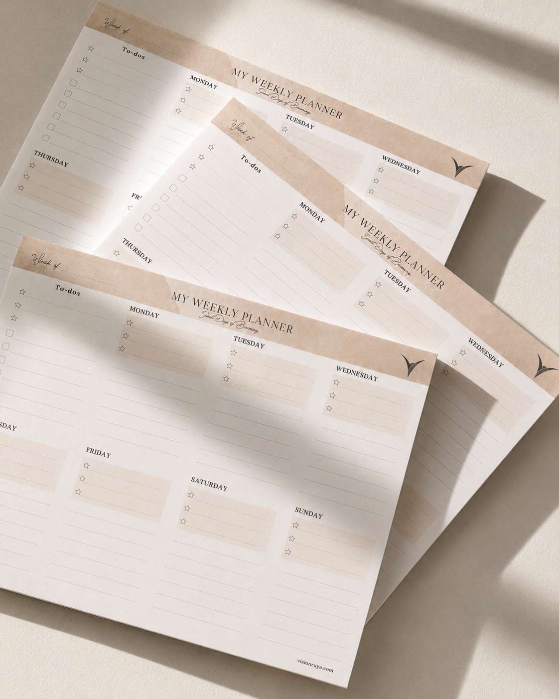 Stack of weekly planner sheets in warm light